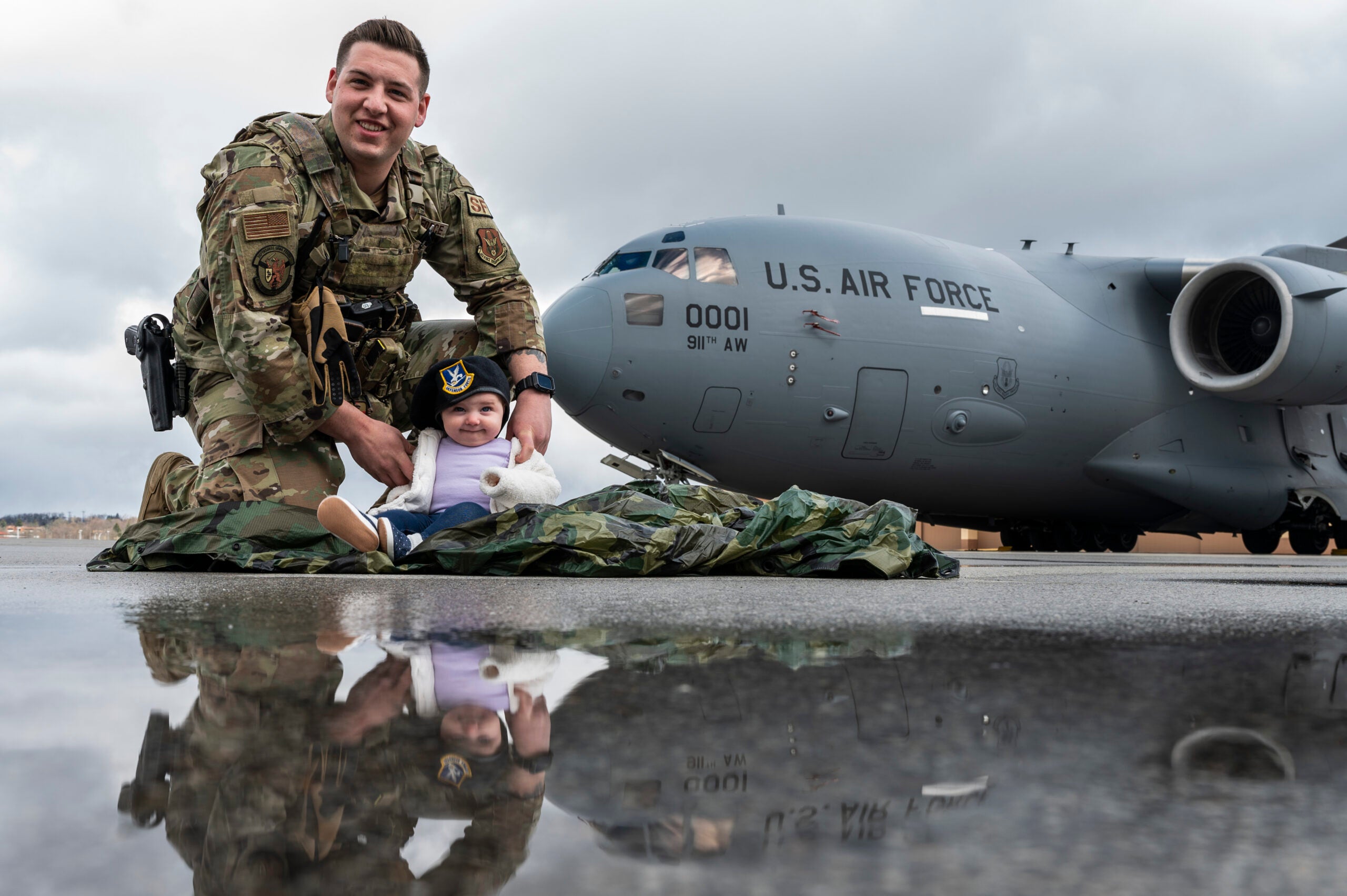 An Airman assigned to the 911th Security Forces Squadron poses for a photo with his daughter at the Pittsburgh International Airport Air Reserve Station, Pennsylvania, April 9, 2022. April is designated as the Month of the Military Child by the Department of Defense Education Activity and was established to underscore the important role children play in the Armed Forces community. (U.S. Air Force photo by Joshua J. Seybert)
